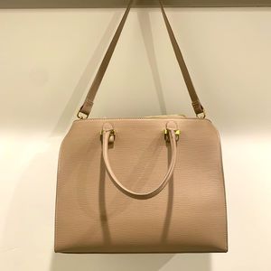 Large bag with side handles and removable shoulder strap.